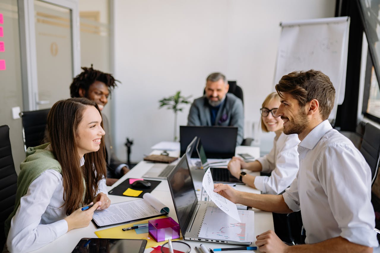 A diverse group of professionals engaging in a collaborative meeting in a modern office environment.